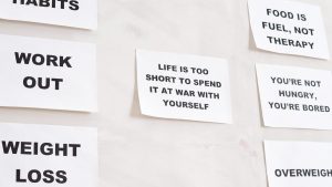 Motivational quotes on white paper promoting healthy habits and lifestyle changes.